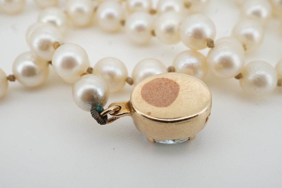 A cultured pearl and aquamarine necklace, composed of a single strand of cultured pearls, to a gold clasp set with an oval aquamarine, length 53.5cm, Condition: in good condition, minor wear, minor variations in pearl co